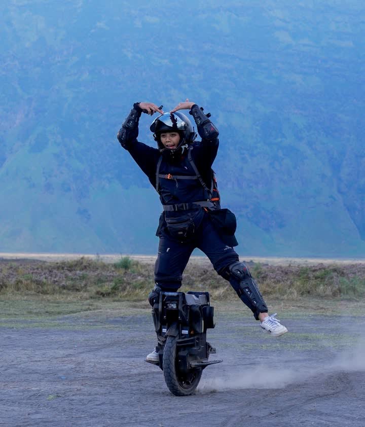 Rider making a heart shape with both hands on the caldera rim