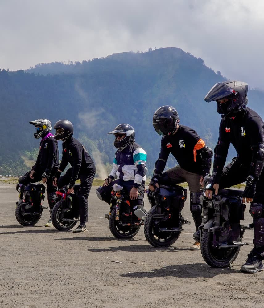 Riders lined up together before a sprint across the sand