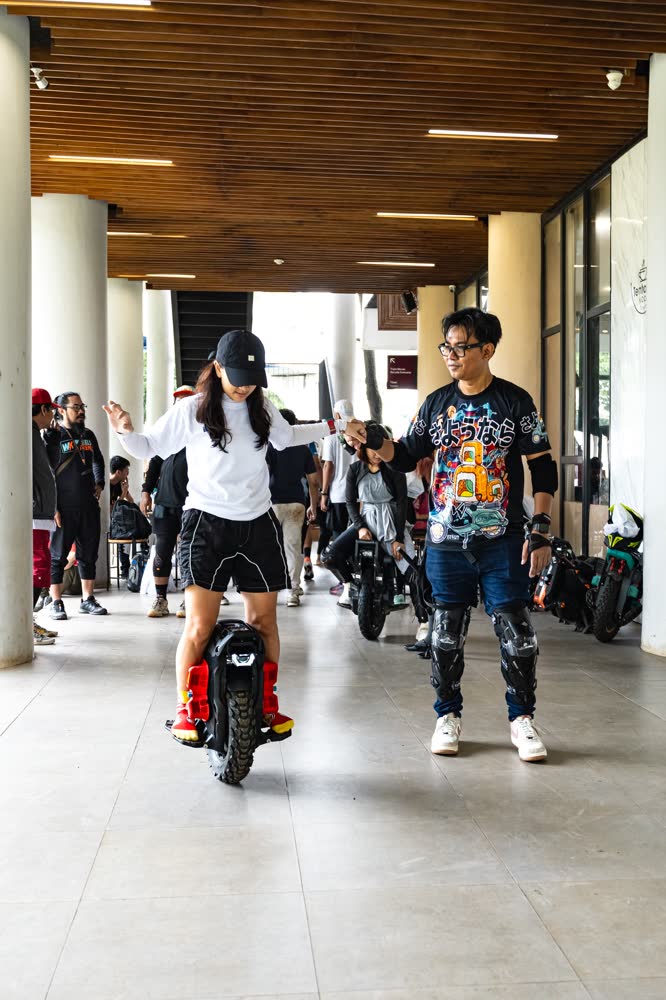 Riders moving down a covered walkway