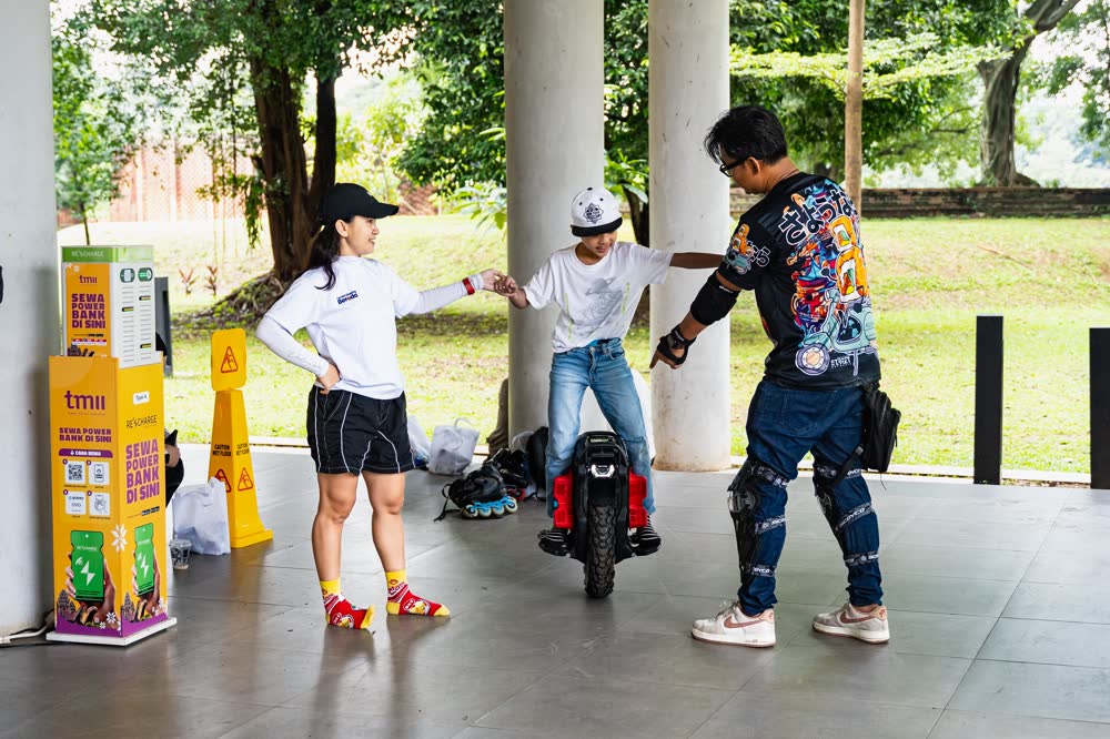 Riders resting beside a pillar in the park