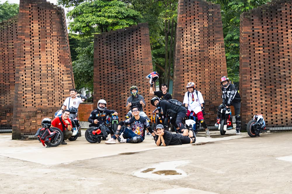 Riders gathered at a red brick temple gate