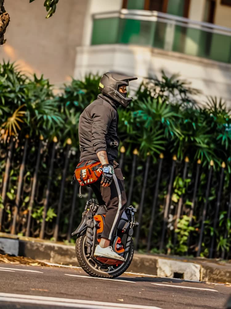 Rider carving past a fence and hedge