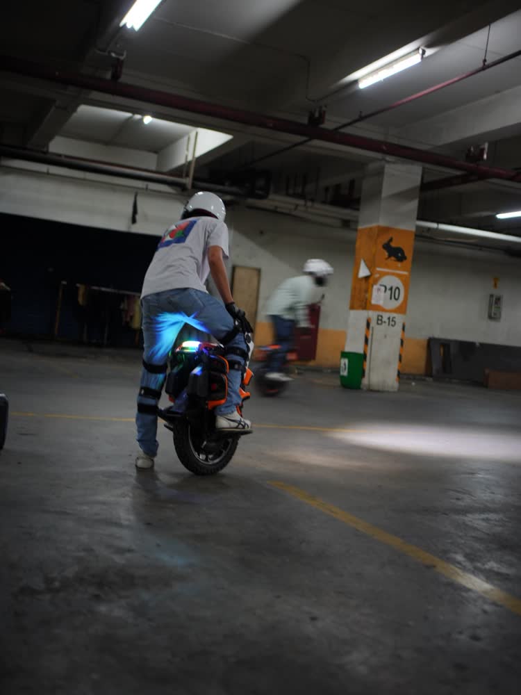 Rider seen from behind with blue underglow