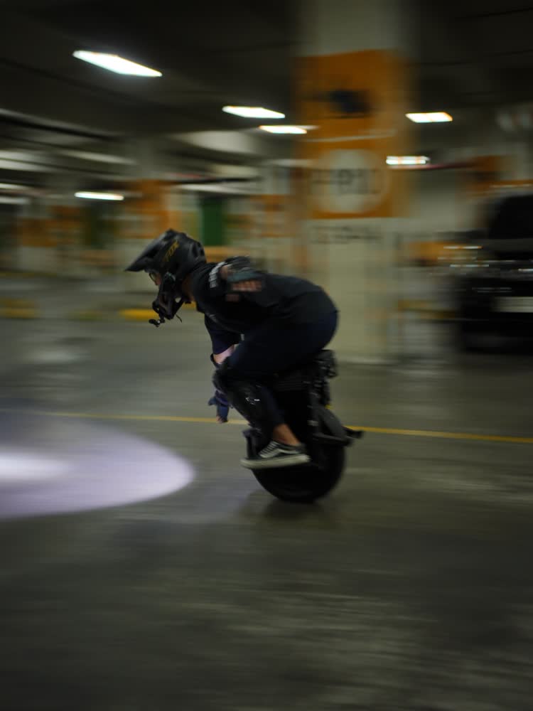 Rider leaning through a pool of purple light
