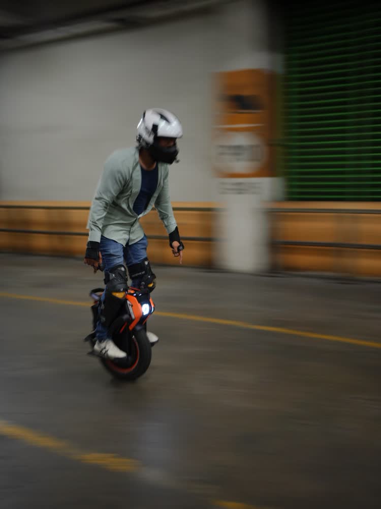 Rider passing a row of green shutter doors