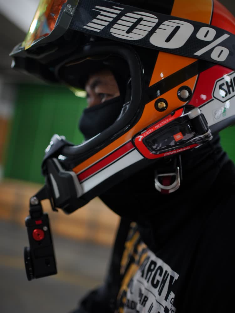 Close-up of a rider's full-face helmet and chest protection
