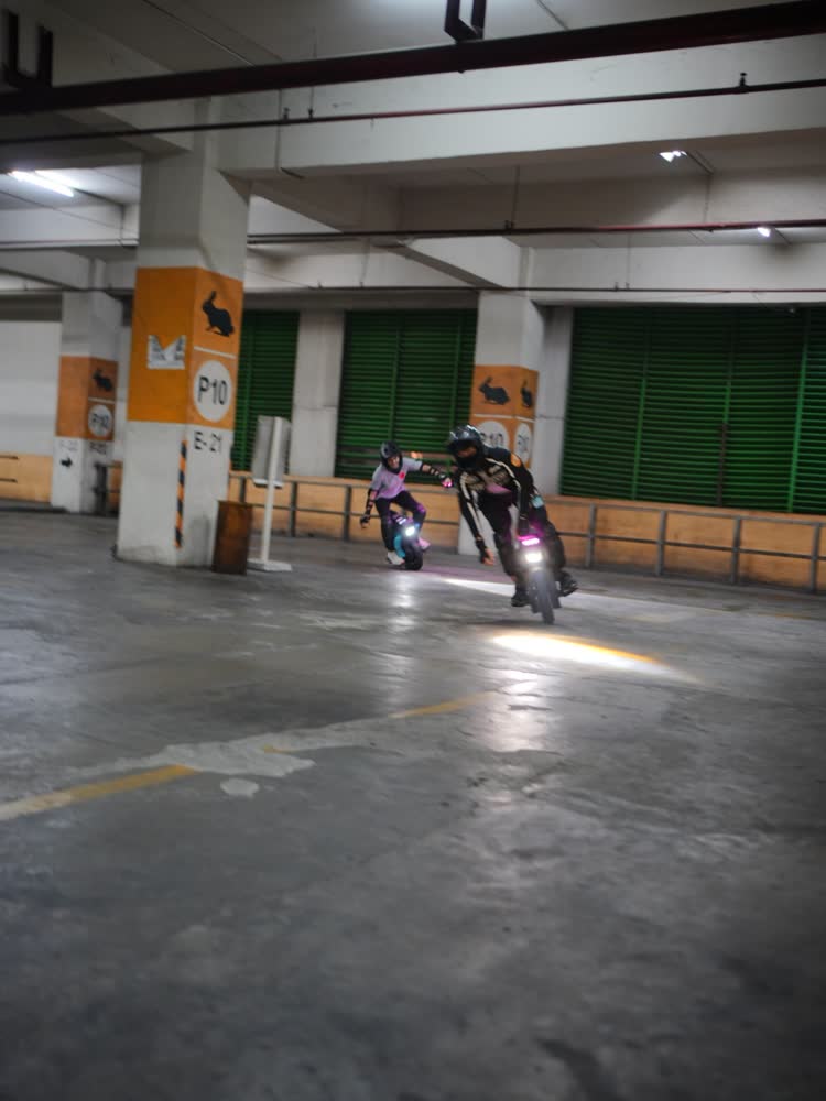 Distant rider on a long straight run of empty garage