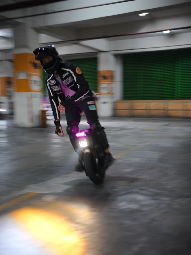 Rider trailing pink light on a late run