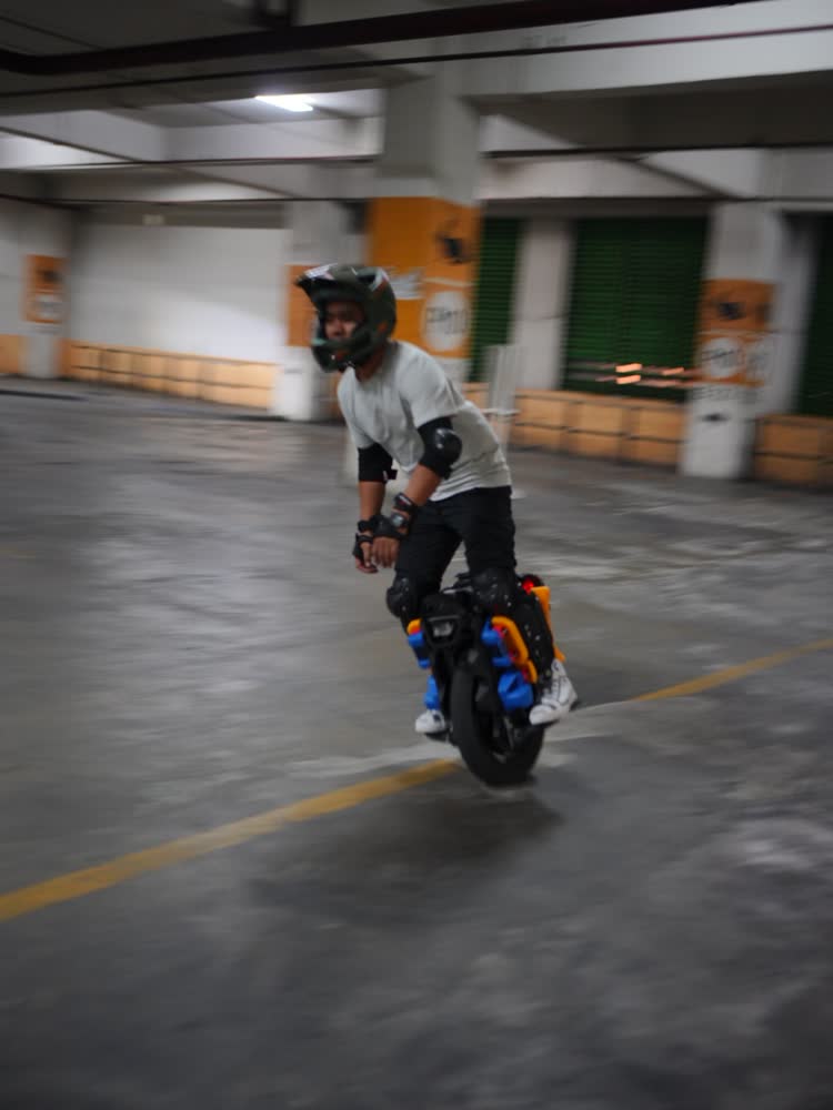 Rider in a white tee with blue underglow