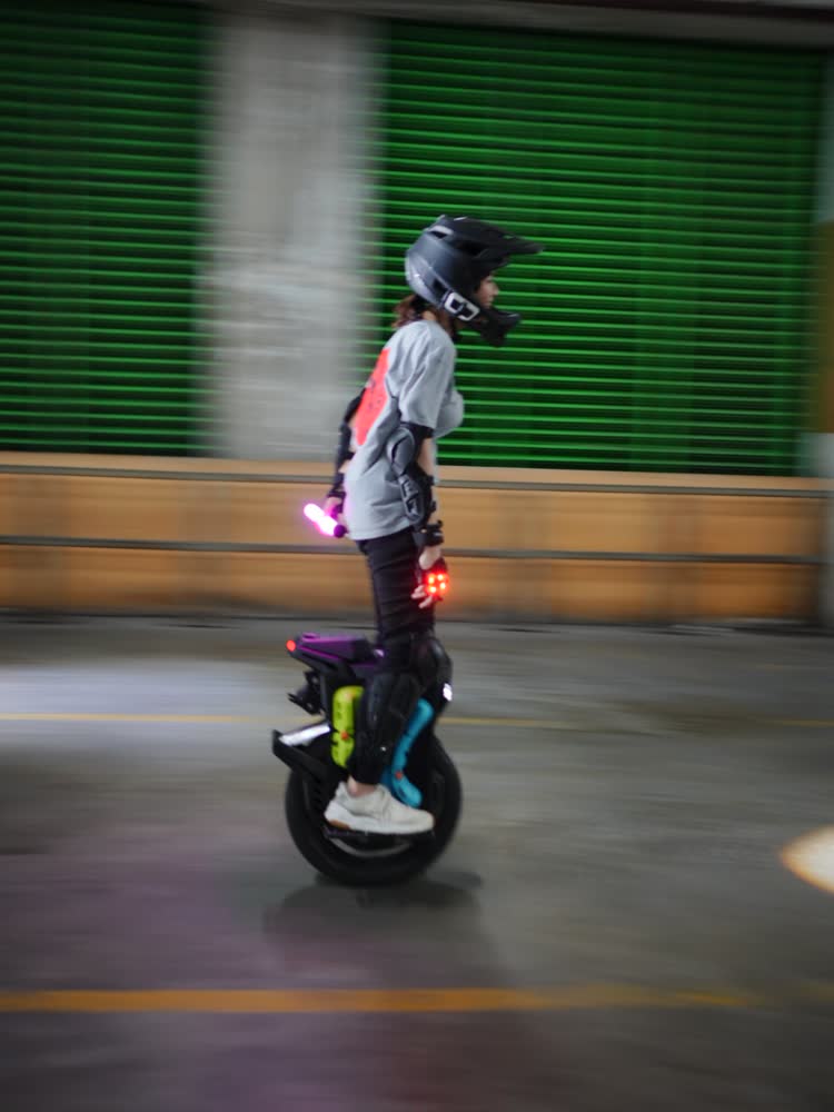 Rider with a red tail light against green shutters
