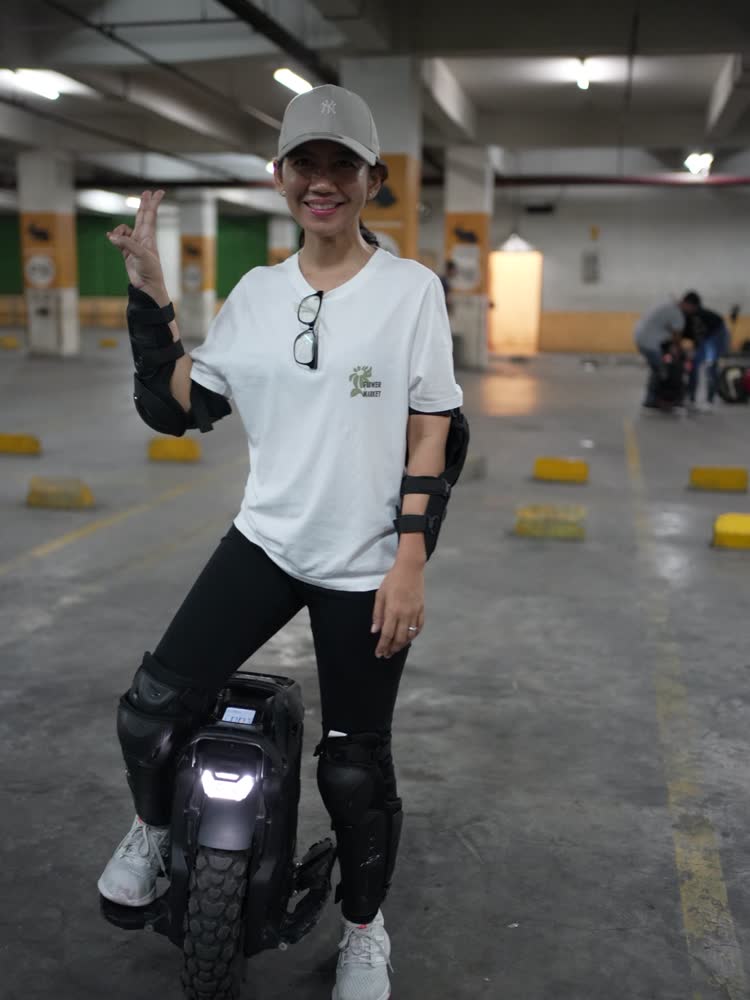 Rider waving at the camera with headlight on