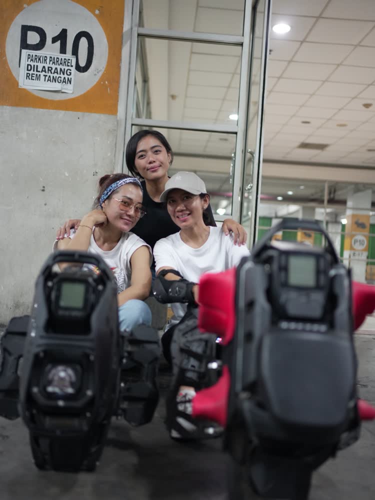 Three riders posed behind their wheels