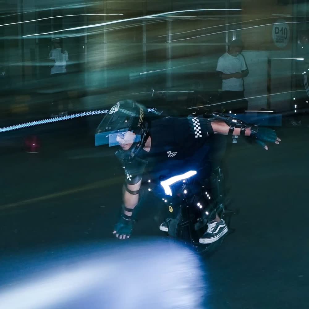 Rider leaning low with light streaks trailing behind