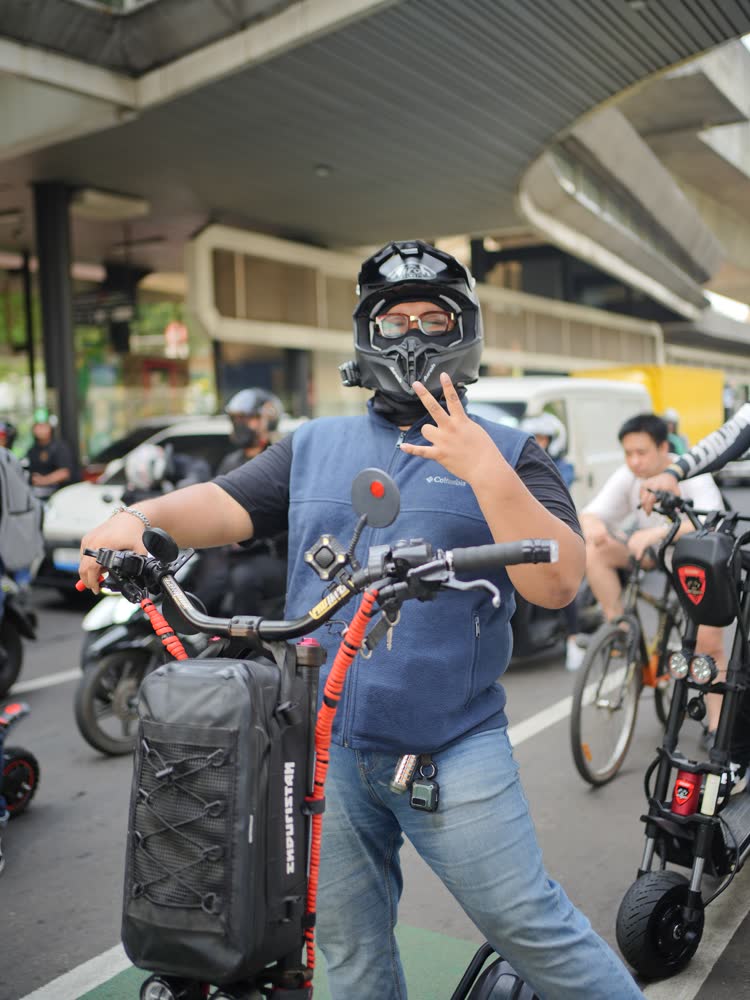 Rider with a large luggage bag strapped to the machine